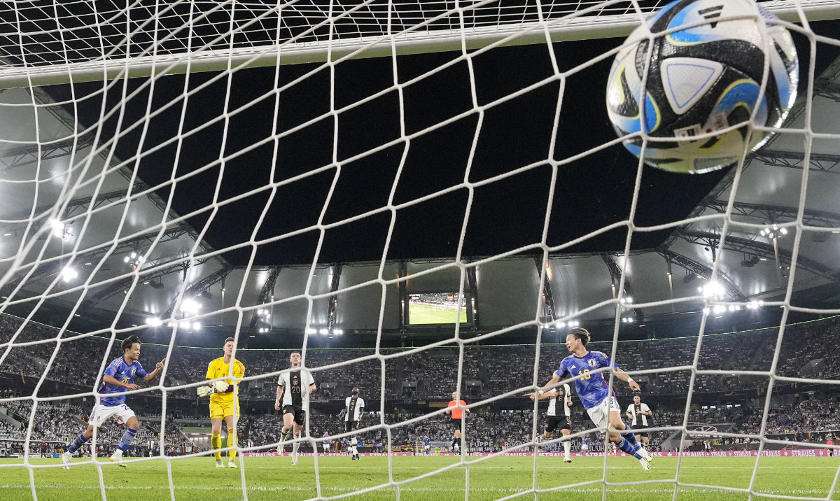 Japan's Takuma Asano, right, scores his side's third goal during an international friendly soccer match between Germany and Japan in Wolfsburg Saturday. Germany lost 4-1. (AP)