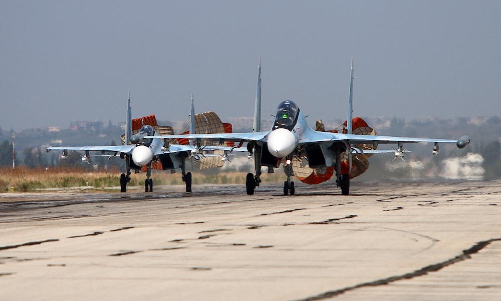 Above, Russian Sukhoi Su-30 fighters land at the Hmeimim airbase in the Syrian province of Latakia on Oct. 3, 2015. (Komsomolskaya Pravda/AFP)