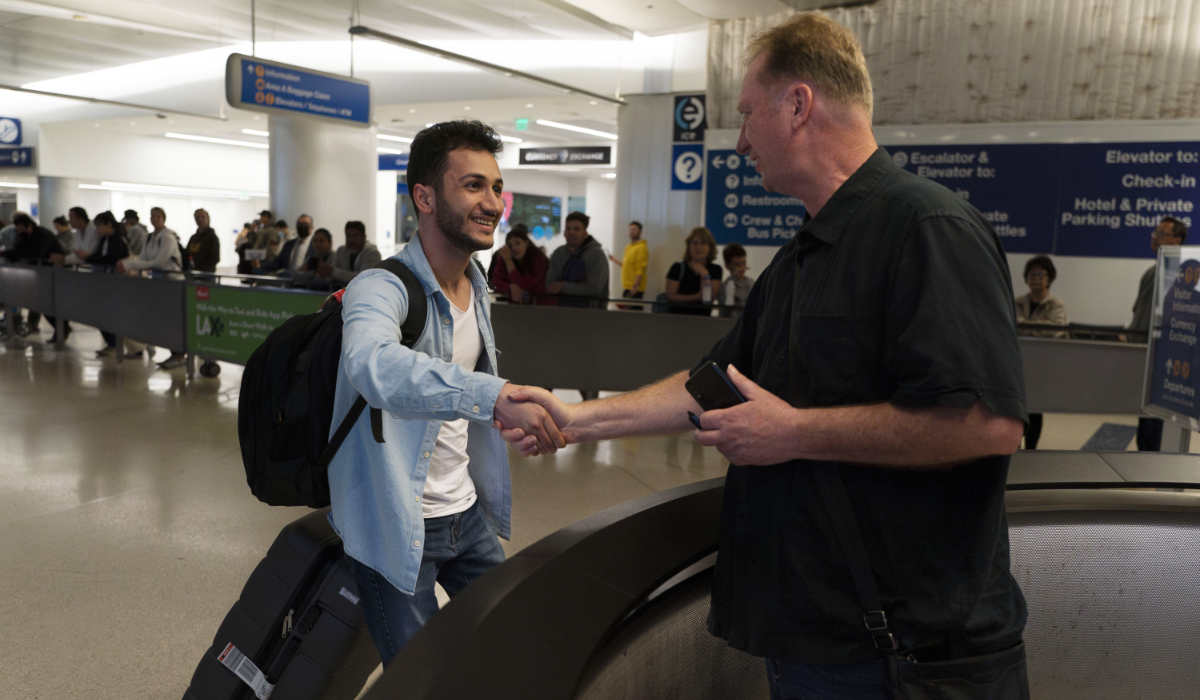 Michael White, a Navy veteran who was jailed in Iran for several years on spying charges, right, shakes hands with Michael's former fellow prisoner and Iranian political activist Mahdi Vatankhah at the Los Angeles International Airport in Los Angeles, Thursday, June 1, 2023. (AP)