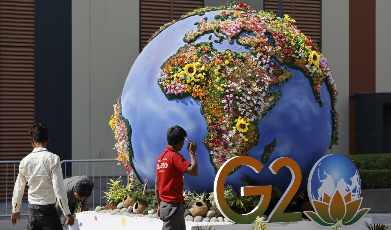 Workers decorate a G20 installation at the International Media Center (IMC) on the eve of the two-day G20 summit in New Delhi on September 8, 2023. (AFP)
