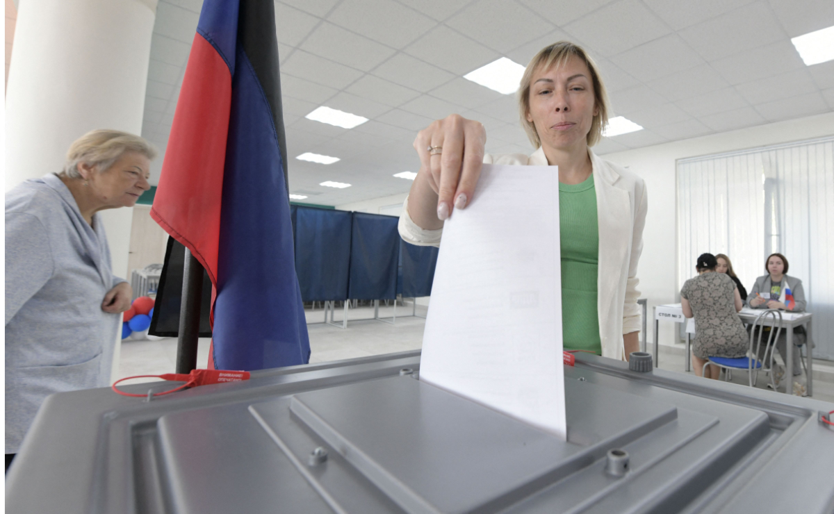 A woman votes at a polling station during local elections organised by the Russian-installed authorities in Donetsk, Russian-controlled Ukraine, on September 8, 2023. (AFP)