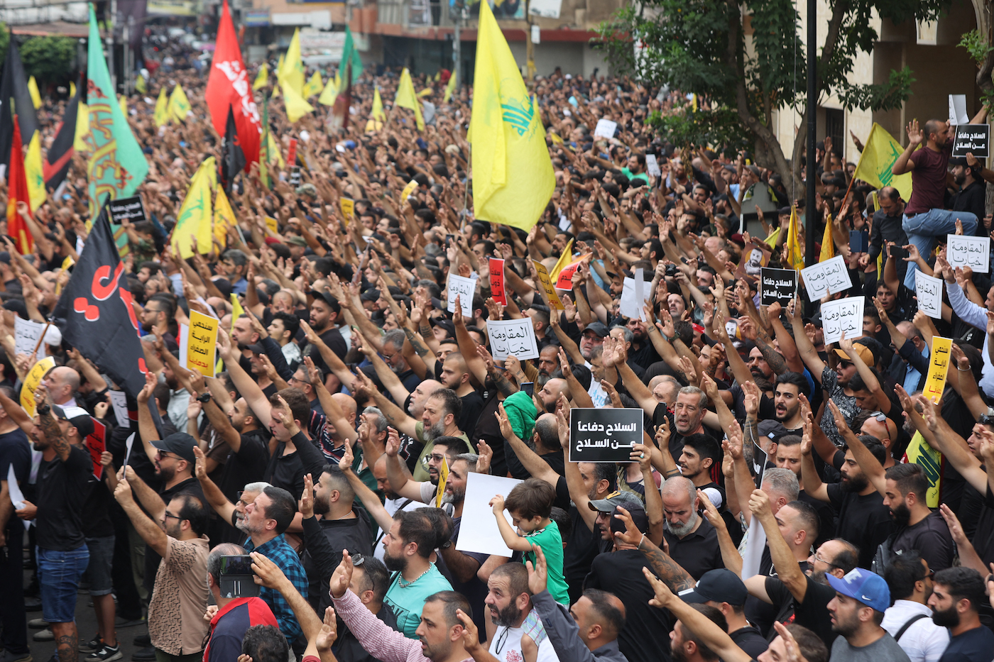 People chant slogans during the funeral of a Hezbollah fighter in Beirut’s predominantly-Shiite Muslim southern suburb. (File/AFP)
