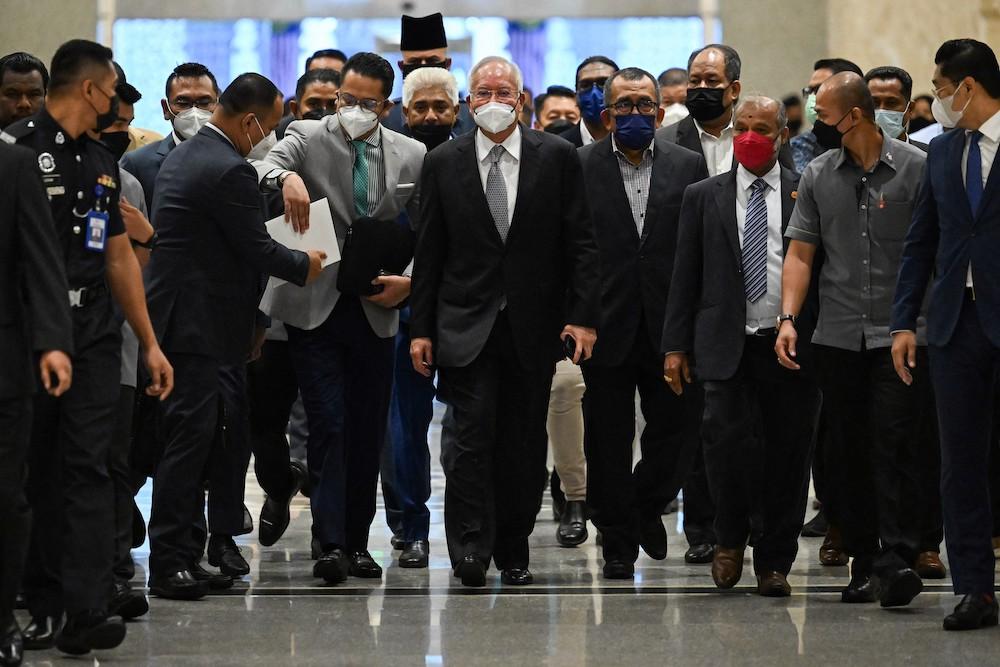 Former Malaysian Prime Minister Najib Razak, center, was acquitted in March after the High Court ruled prosecutors failed to show that he abused his position to order amendments to a 1MDB audit report in 2016. (AFP)