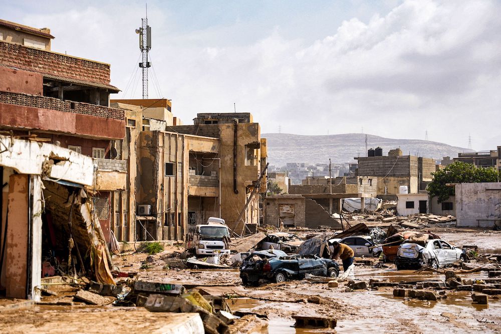 Above, destroyed vehicles and damaged buildings in the eastern city of Derna in the wake of storm Daniel. (Media ffice of Libyan prime minister/AFP)