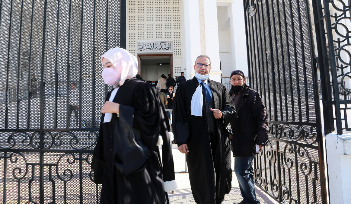 Tunisian citizens and lawyers leave the court of the governorate of Ariana after the announcement of a strike of the judges on February 9, 2022 following the dissolution of the Supreme Council of the Judiciary by President Saied. (AFP)