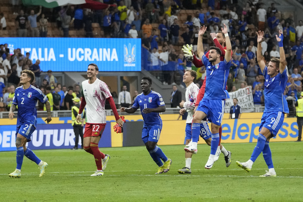 Italy’s players celebrate at the end of the Euro 2024 group C qualifying match between Italy and Ukraine at the San Siro stadium, in Milan on Tuesday. (AP)