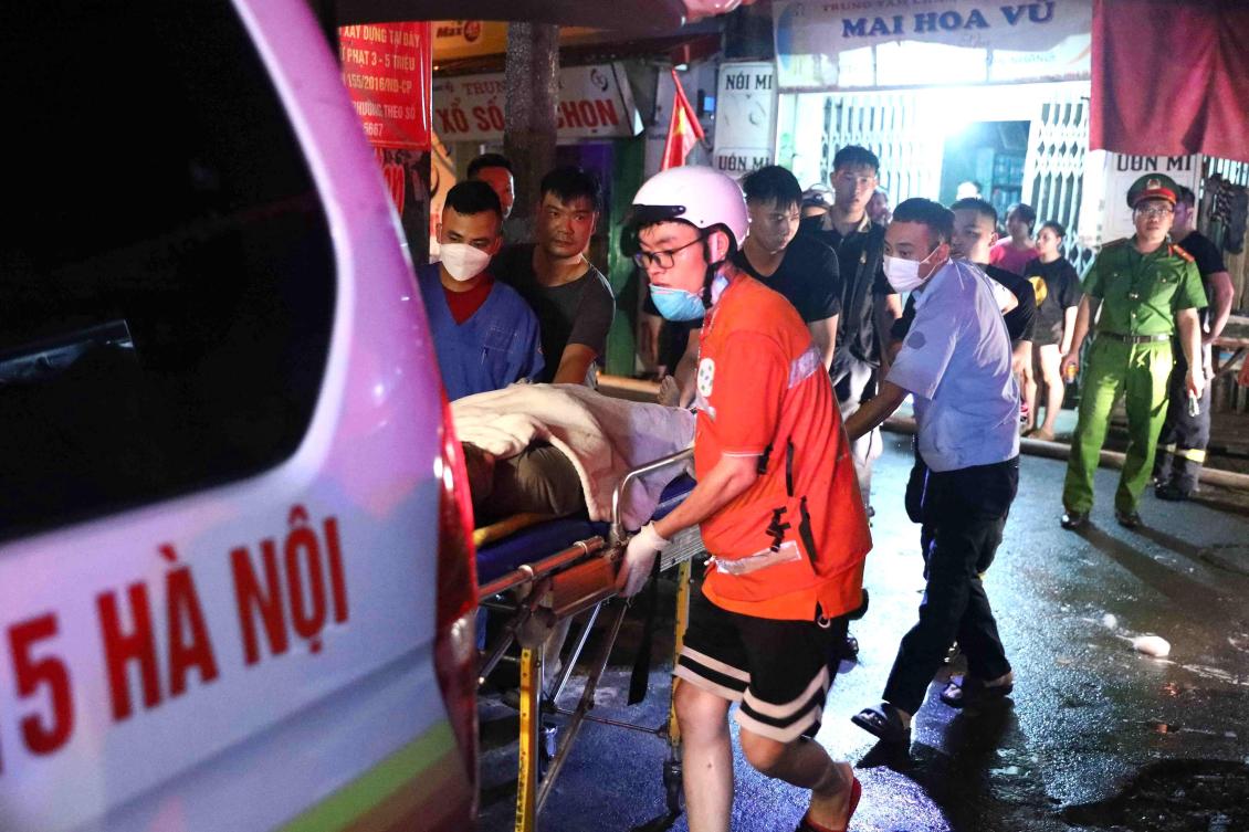Rescue workers transport victims following a major fire at an apartment block in Hanoi on Sept. 13, 2023. (Vietnam News Agency/AFP)