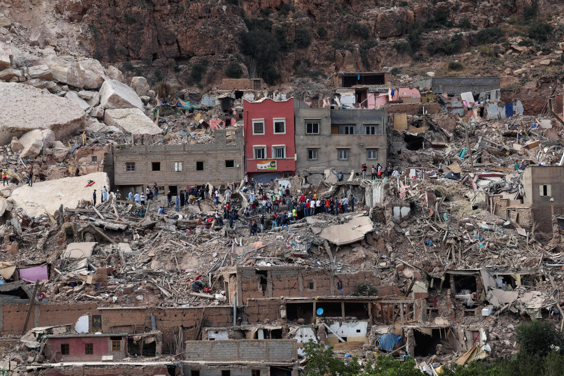 People stand on rubble in Imi N’Tala village, that was devastated by a deadly earthquake, Morocco on Sept.12, 2023. (Reuters)