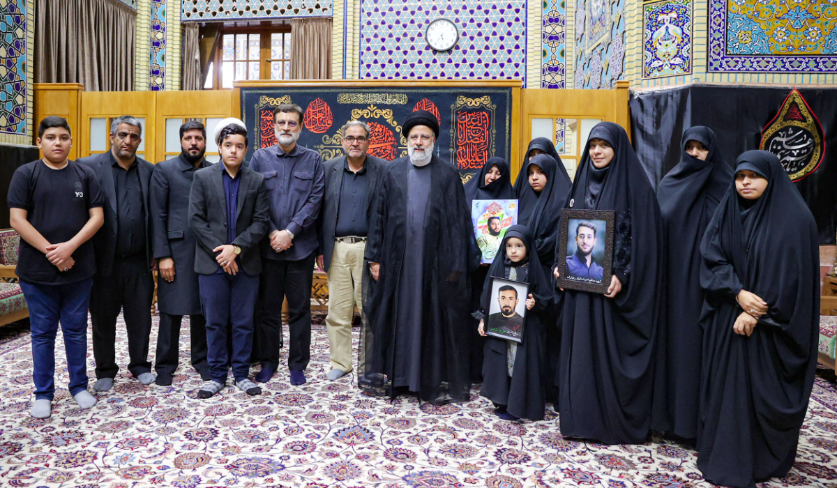 A handout picture provided by the Iranian presidential office shows Iranian President Ebrahim Raisi meeting with families of security personnel killed during mass protests sparked by the death in custody of Mahsa Amini last year, in Mashhad, late on September 15 2023. (AFP)