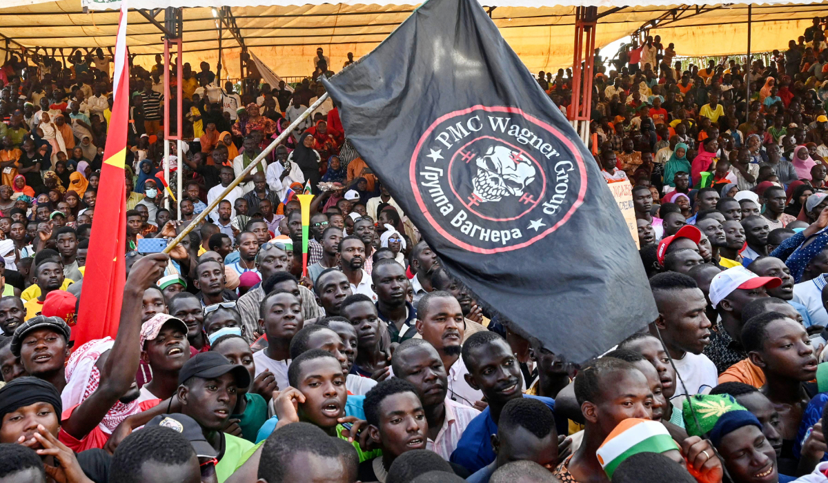 Supporters of Niger's National Council of Safeguard of the Homeland (CNSP) wave a flag bearing the logo of private military Company (PMC) Wagner, as they protest ouside the Niger and French airbase to demand the departure of the French army from Niger, in Niamey on September 16, 2023. (AFP)