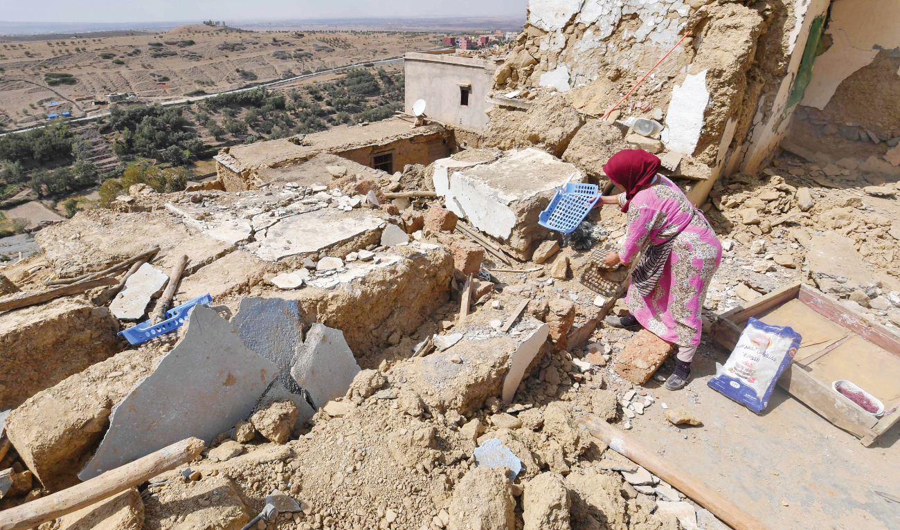 A woman salvages belongings from the rubble of her house in the village of Afella Igir in the Amizmiz region. The magnitude 6.8 earthquake flattened entire villages on Sept. 8. (AFP)