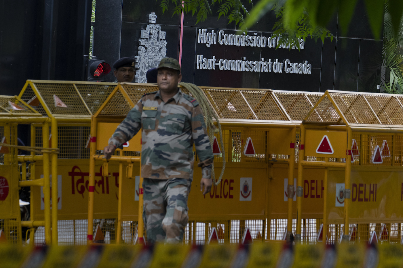An Indian paramilitary soldier stands guard next to a police barricade outside the Canadian High Commission in New Delhi, India, Tuesday, Sept. 19, 2023. (AP)