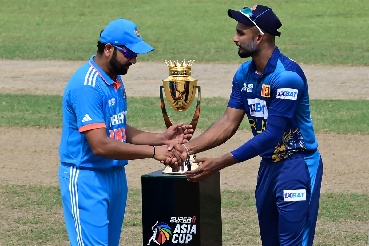 India's captain Rohit Sharma (L) and Sri Lanka's captain Dasun Shanaka shake hands after the toss prior to the start of the Asia Cup 2023 one-day international (ODI) final cricket match between India and Sri Lanka at the R. Premadasa Stadium in Colombo (AFP)