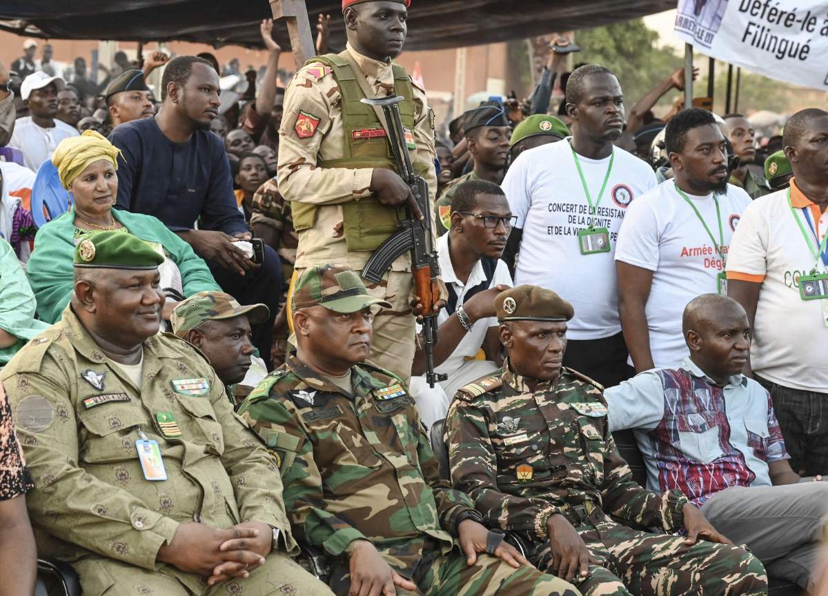 Niger's National Concil for Safeguard of the Homeland (CNSP) leaders Colonel Mamane Sani Kiaou (L), General Moussan Salaou Barmou (C) and Colonel Ibroh Bachirou (2-R) attend the CNSP support concert in front of the Niger and French airbase in Niamey on September 10, 2023. (AFP)