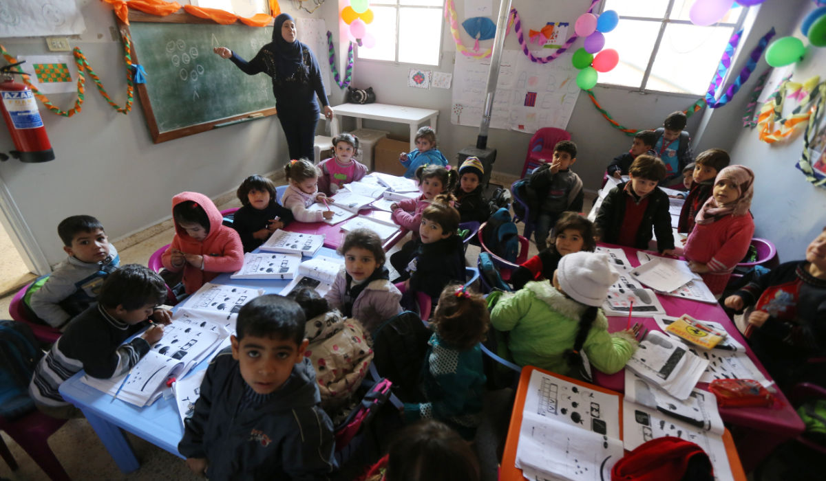 Syrian refugee children attend a class at a school for Syrian refugees in the Lebanese village of Qaraoun, in the west of the Bekaa Valley. (AFP file photo)