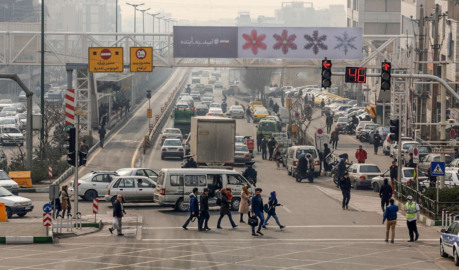 A general view shows Iranians crossing the road in Tehran, Iran, on February 5, 2018. (AFP/File)