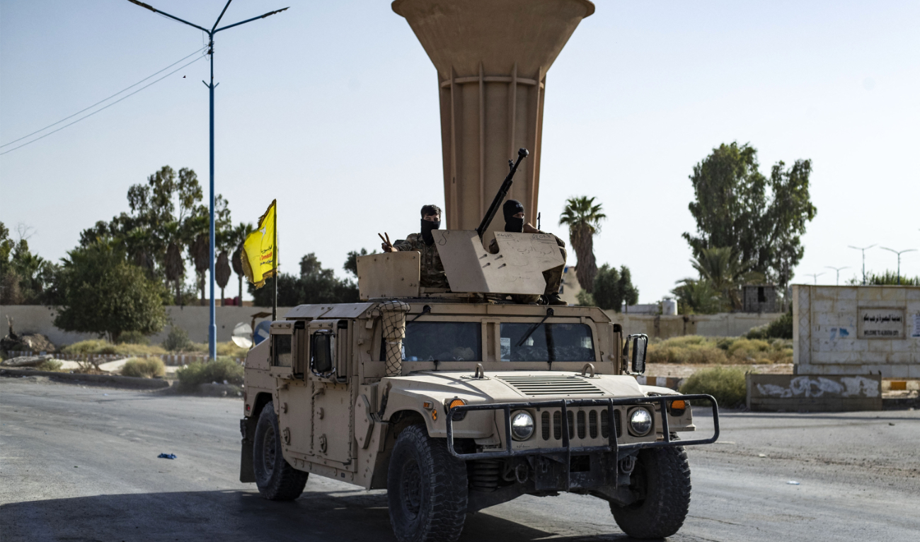 A vehicle of the Syrian Democratic Forces (SDF) is pictured along a road as fighters deploy to impose a curfew in the town of Al-Busayrah in Syria’s northeastern Deir Ezzor province on September 4, 2023. (AFP/File)