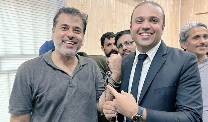 Pakistani news anchor Imran Riaz Khan (L) smiles as he poses for a photo with his lawyer after his arrest on July 6, 2022. (Imran Riaz Facebook/File)