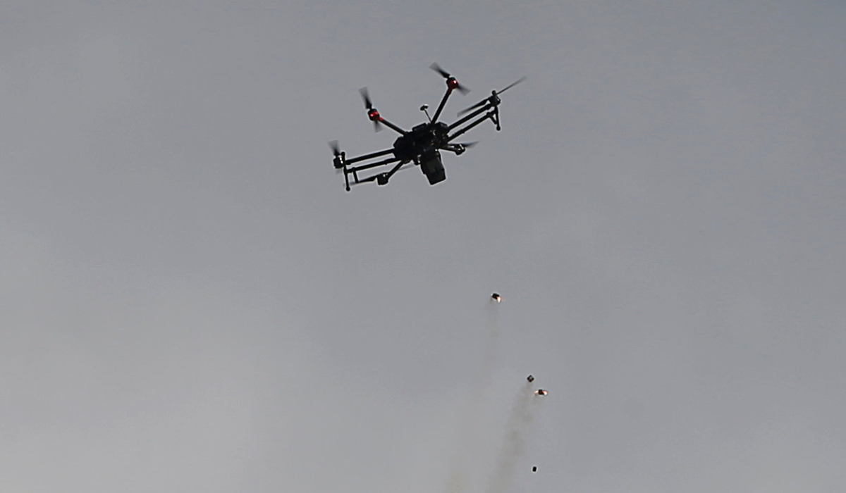 An Israeli drone drops tear gas grenades during clashes with Palestinians, during a tent city protest along the Israel border with Gaza, demanding the right to return to their homeland, east of Gaza City March 30, 2018. (REUTERS)