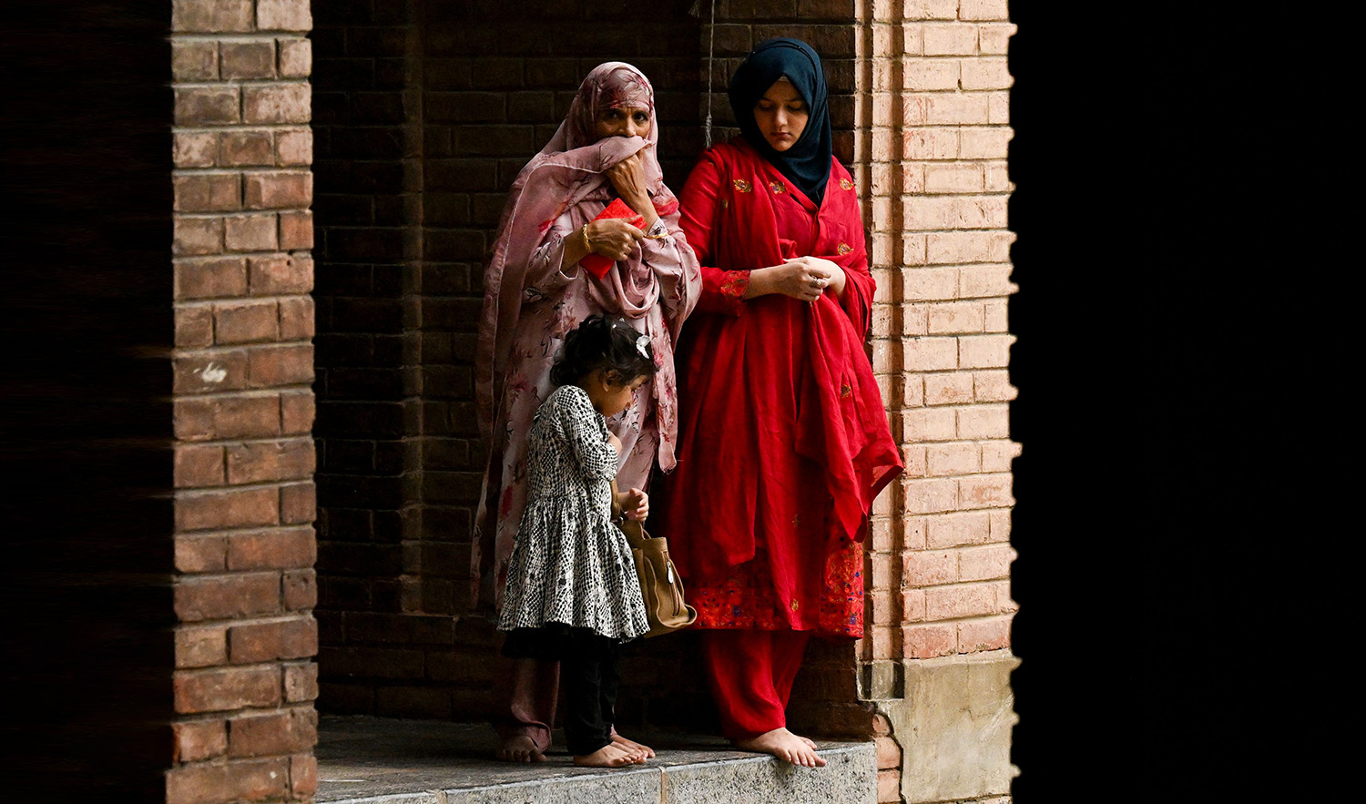 Kashmiri Muslim women watch while senior separatist leader Mirwaiz Umar Farooq released after four years of house arrest, delivers the friday sermon at Jamia Masjid in downtown Srinagar on September 22, 2023. (AFP)