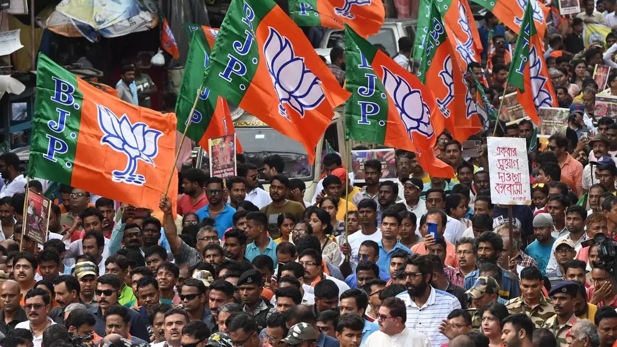 Bharatiya Janata Party (BJP) activists hold party flags during a rally in Kolkata, India, on July 19, 2023. (AFP/File)