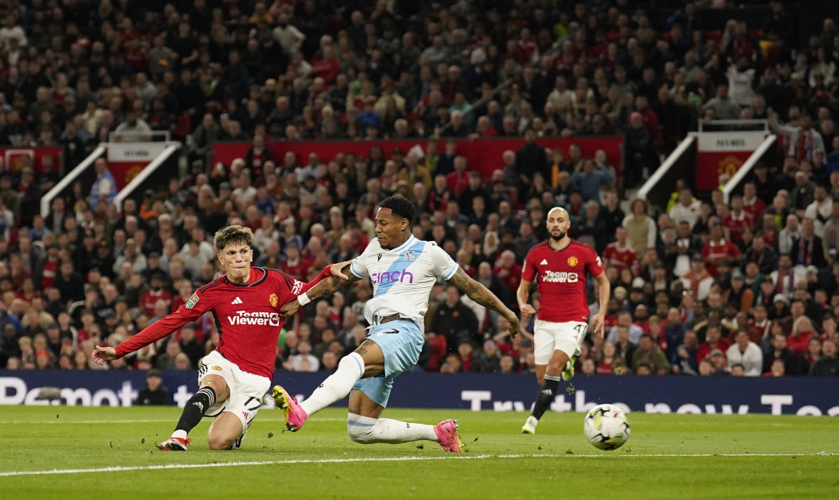 Manchester United's Alejandro Garnacho, left, scores his side's opening goal during the English League Cup third round soccer match between Manchester United and Crystal Palace at Old Trafford stadium in Manchester, England, Tuesday. (AP)
