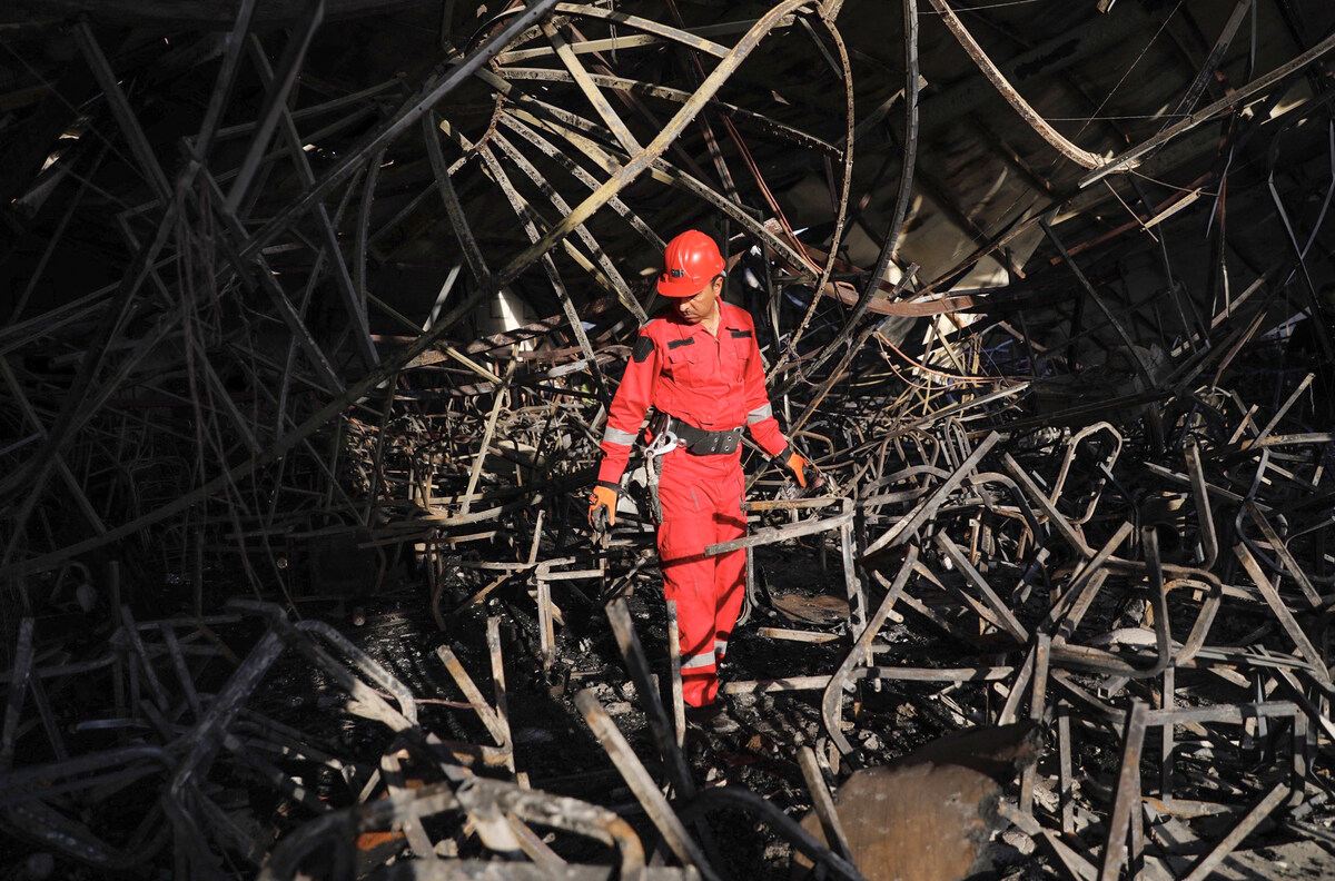 A firefighter checks the damage in an event hall in Qaraqosh, also known as Hamdaniyah, after a fire broke out during a wedding, killing at least 100 people and injuring more than 150 (AFP)