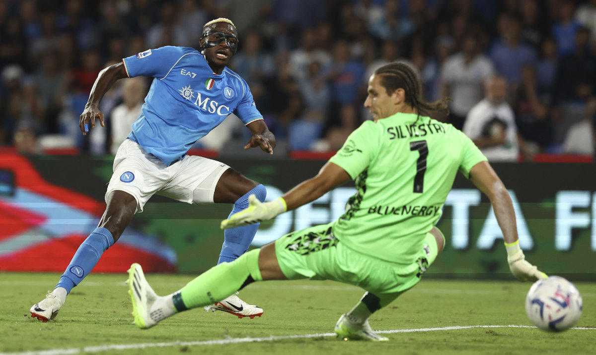 Napoli's Victor Osimhen, left, scores their side's second goal of the game during the Serie A soccer match between Napoli and Udinese at the Diego Armando Maradona stadium in Naples Wednesday. (AP)