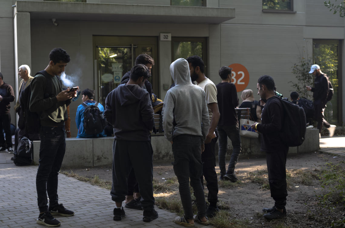 Dozens of people from all over the world line in front of the central registration center for asylum seekers in Berlin, Germany, Monday, Sept. 25, 2023. Across Germany, officials are sounding the alarm that they are no longer in a position to accommodate migrants who are applying for asylum. (AP)