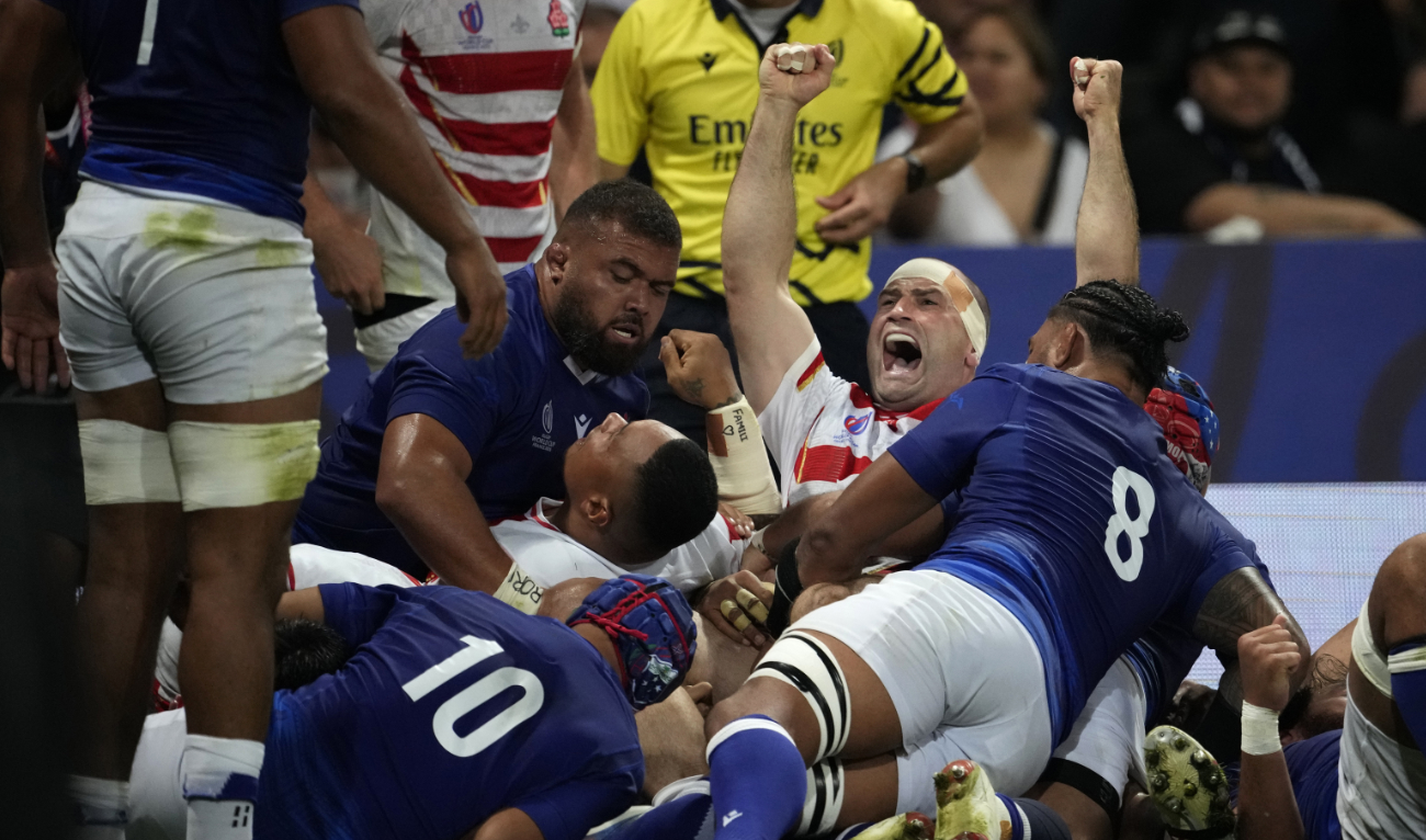 Japan's Craig Millar, centre, celebrates after his captain Kazuki Himeno scored a try during the Rugby World Cup Pool D match between Japan and Samoa, at the Stadium de Toulouse in Toulouse, France, Thursday. (AP)