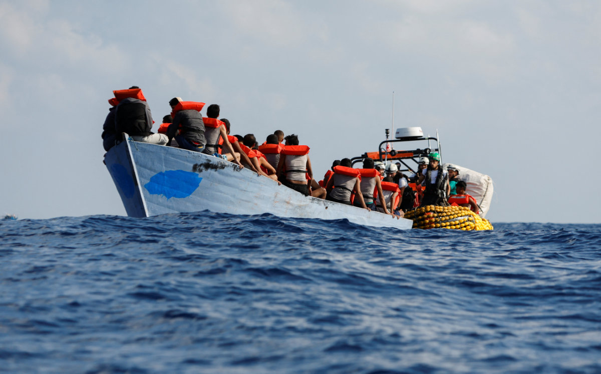 A group of 61 migrants on a wooden boat are rescued by crew members of the Geo Barents migrant rescue ship, operated by Medecins Sans Frontieres, in the central Mediterranean Sea on September 28, 2023. (REUTERS)