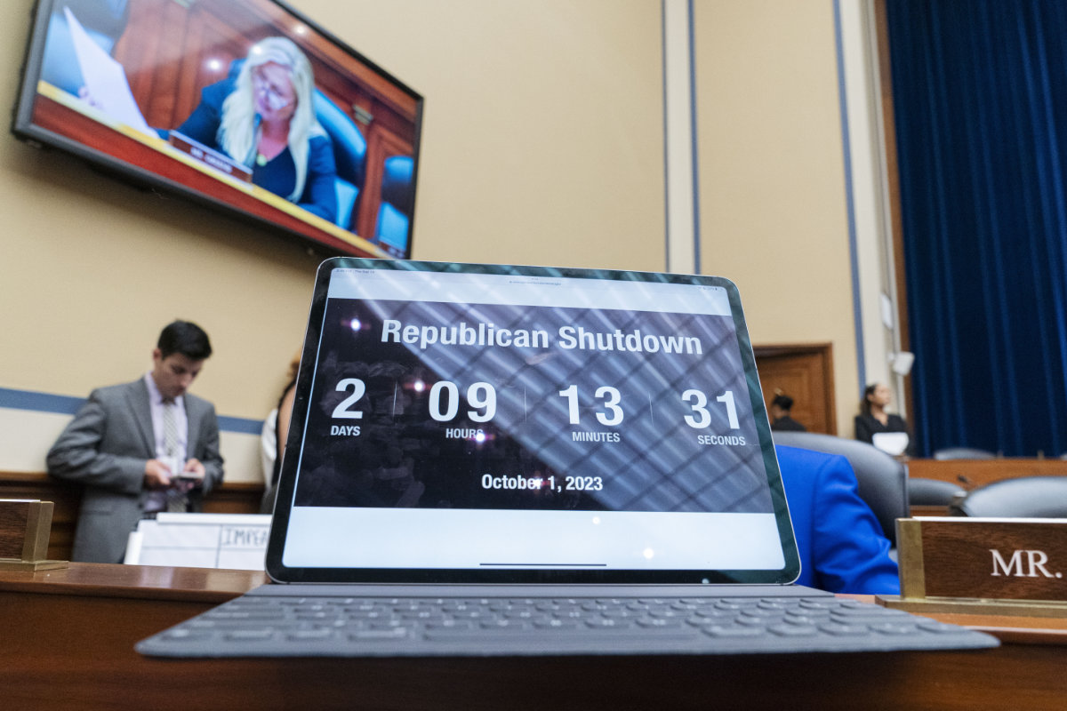 A countdown clock about the time left before a government shutdown is seen in the foreground as Rep. Marjorie Taylor Greene is seen on a screen during a House Oversight Committee impeachment inquiry into President Joe Biden on Sept. 28, 2023, in Washington. (AP)