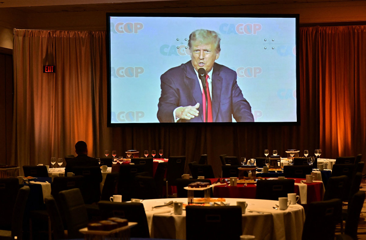 Former US president and 2024 Republican presidential candidate Donald Trump delivers his speech as seen on a screen in the spillover room at the Anaheim Mariott on September 29, 2023 during the California Republican Party (CAGOP) Fall Convention in Anaheim, California. (Photo by Frederic J. BROWN / AFP)