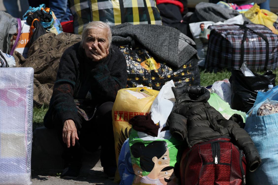 Above, an elderly woman sits as she waits to be evacuated as the exodus from the Nagorno-Karabakh continues unabated. (AFP)
