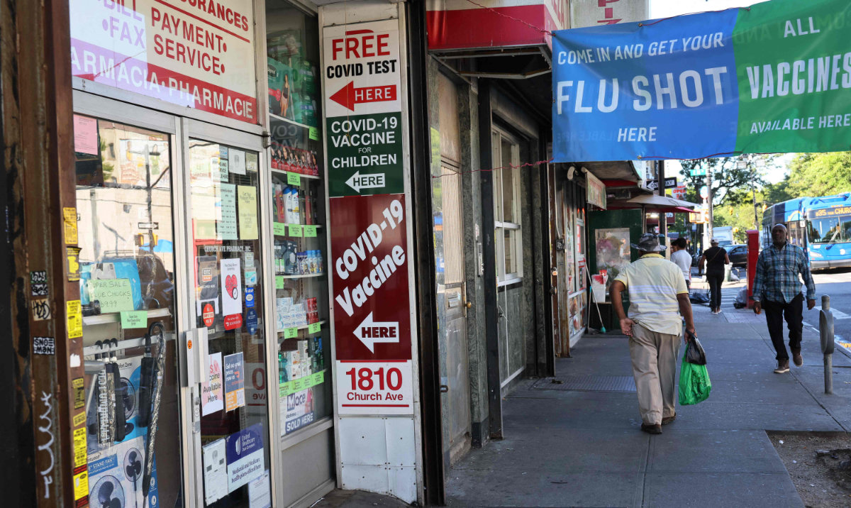 A sign for COVID-19 vaccination is seen on a door of a pharmacy on September 01, 2023 in New York City. (AFP)