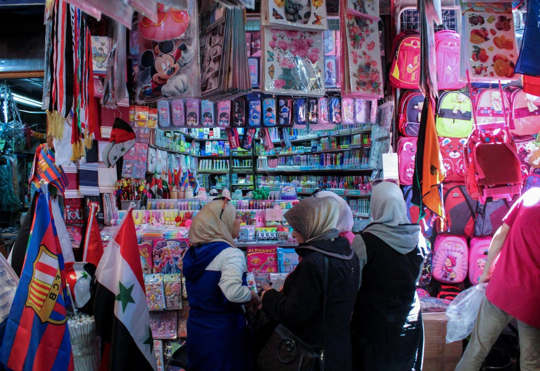 People shop for school supplies at a market in Damascus, Syria August 27, 2023. (Reuters)
