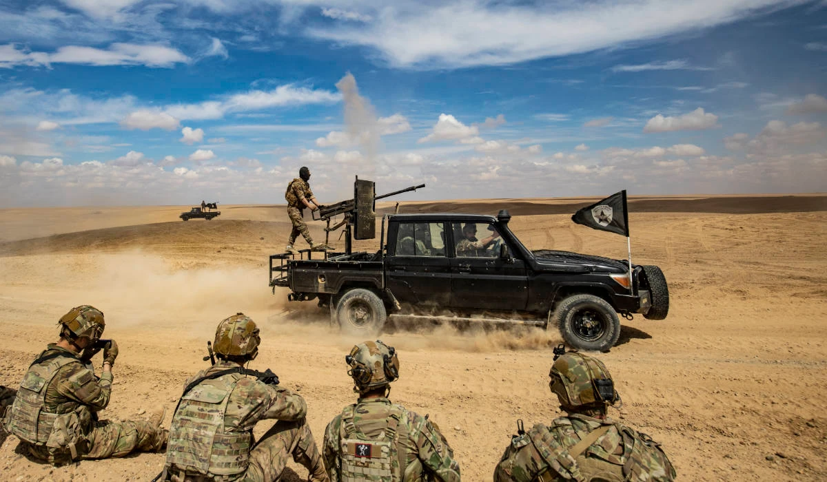 Troops from the Syrian Democratic Forces (SDF) Special Operations and the US-led anti-terrorist coalition, take part in heavy-weaponry military exercises in the countryside of Deir Ezzor in northeastern Syria, on March 25, 2022. (AFP)