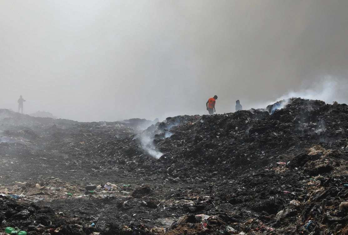 Palestinian firemen extinguish a fire at a landfill in Juhr al-Deek, southeast of Gaza City, September 3, 2023. (Reuters)