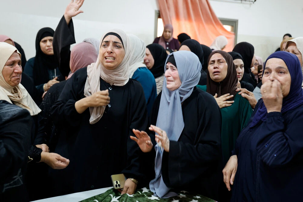 Women mourn the death of Ayed Abu Harb, a Palestinian who was killed in an Israeli raid, during his funeral in Nur Shams camp, near Tulkarm in the Israeli-occupied West Bank, September 5, 2023. (Reuters)