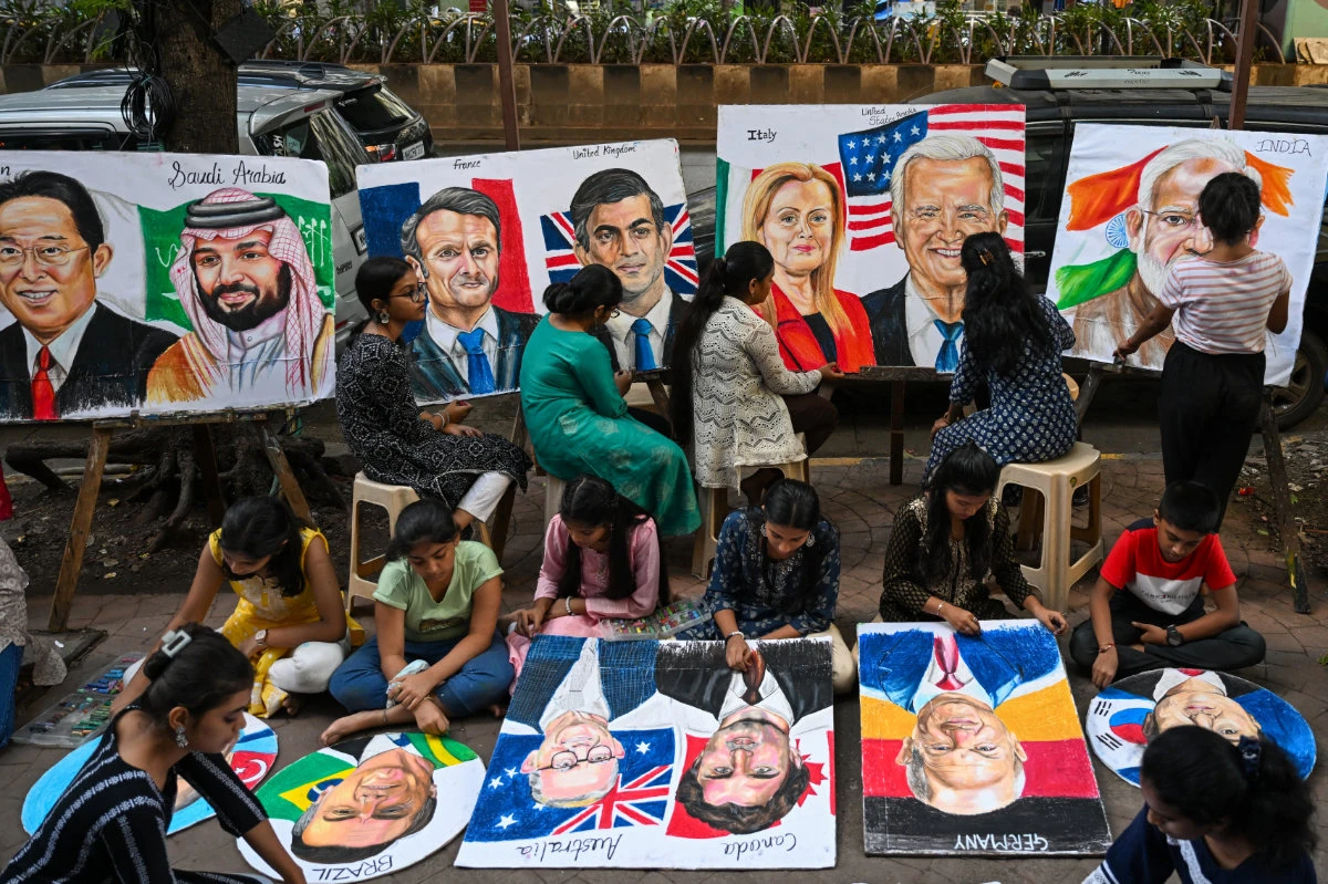 Students work on paintings of world leaders at an art school in Mumbai, main, ahead of the G20 Summit in New Delhi. (AFP)