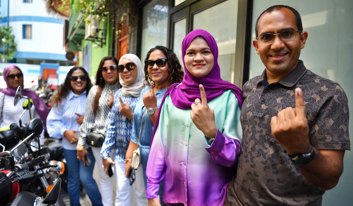 Voters flaunt the electoral ink on their finger after they cast their vote at a polling station in Male on September 9, 2023, during the 2023 presidential election. (AFP)