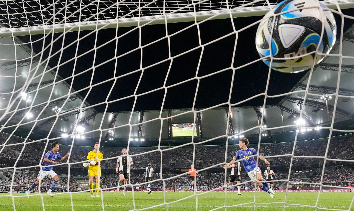 Japan's Takuma Asano, right, scores his side's third goal during an international friendly soccer match between Germany and Japan in Wolfsburg Saturday. Germany lost 4-1. (AP)