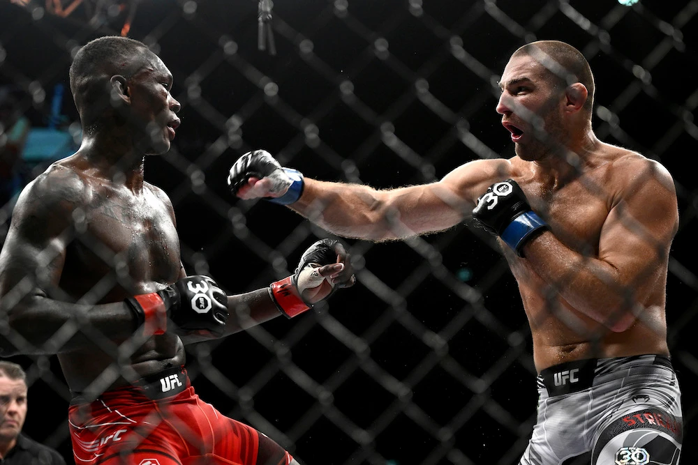 Sean Strickland, right, and Israel Adesanya battle in the middleweight title bout in the main event of UFC 293 in Sydney Sunday. (AAP Image via AP)