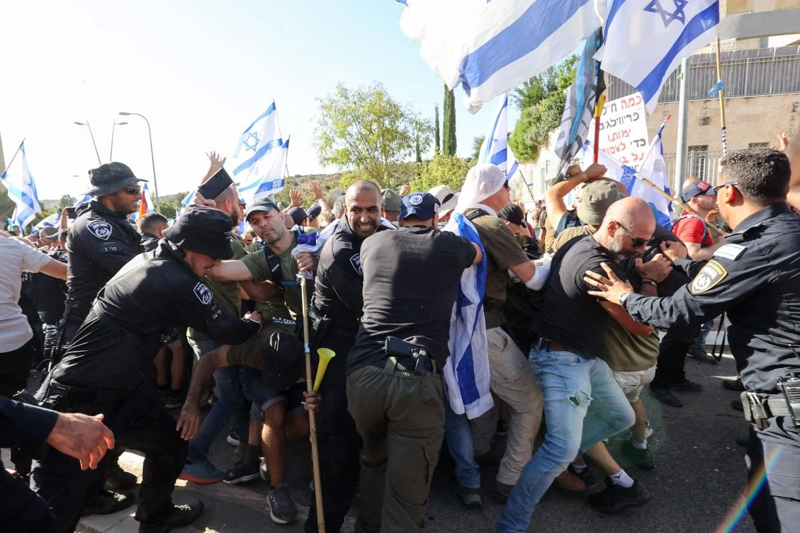 Israeli police disperse protesters as they block the entrance to the residence of Justice Minister Yariv Levin, in the central city of Modiin on September 11, 2023, as they protest against the government’s controversial judicial reform bill. (AFP)
