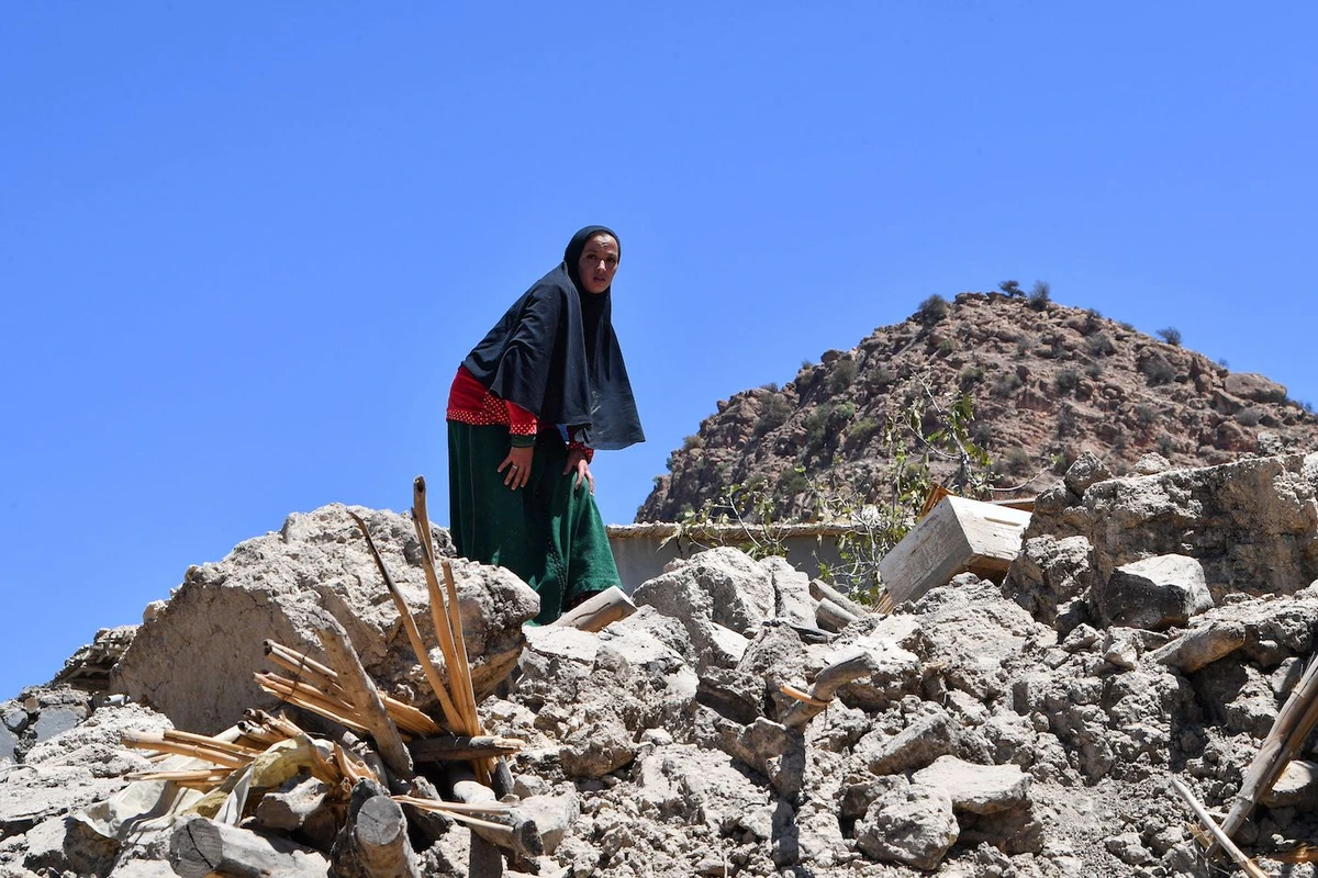 A woman searches through the rubble in the Taroudant province, one of the most devastated in quake-hit Morocco, on September 11, 2023. (AFP)