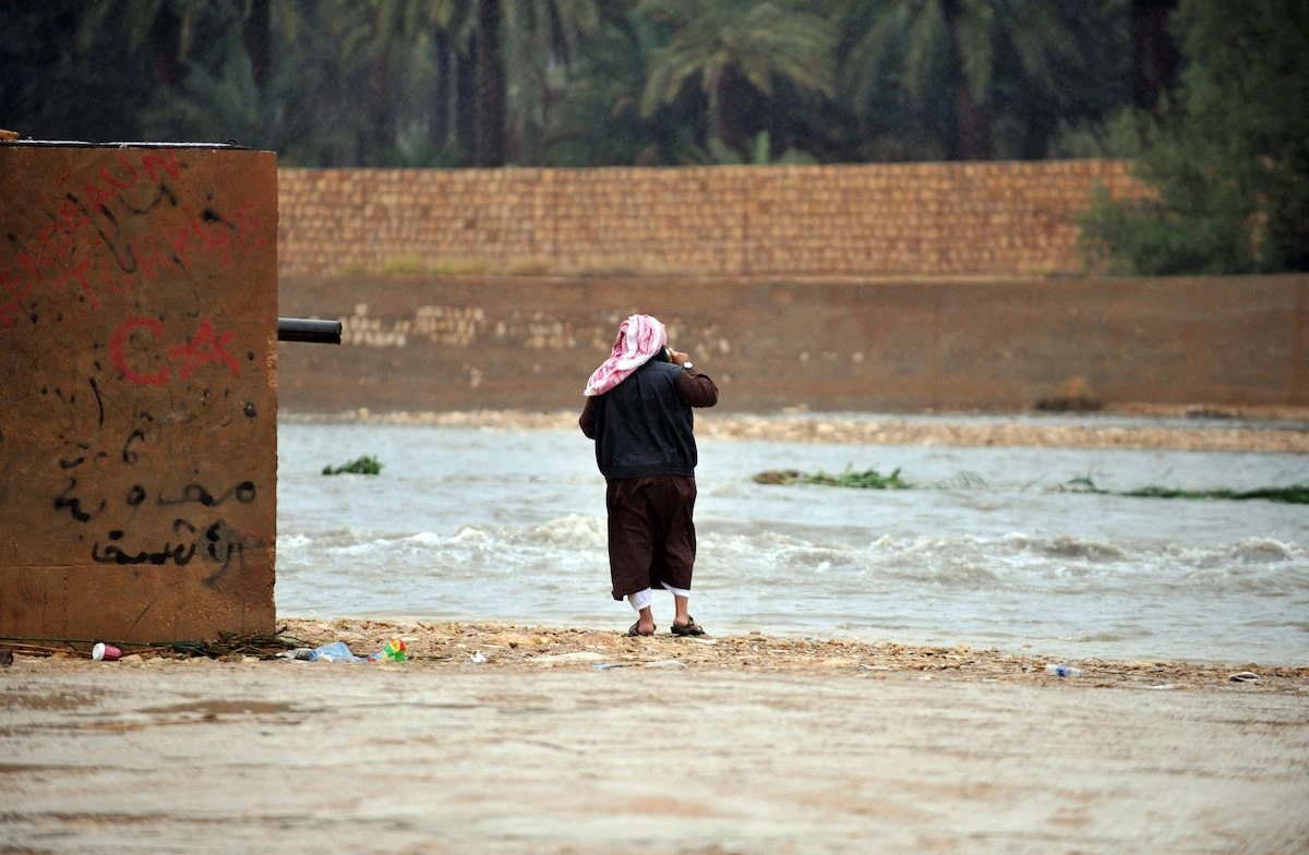 A Saudi man looks at water in the flooded Nimar valley, south of Riyadh. (File/AFP)