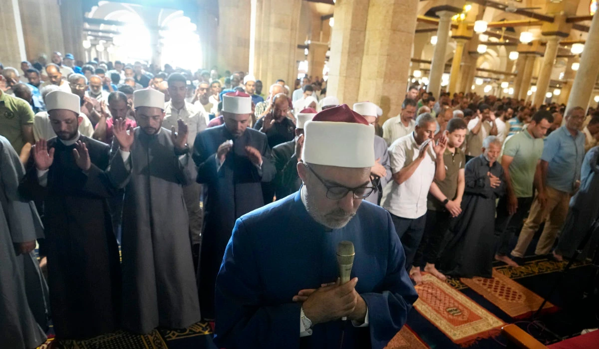Sheikh Nazir Ayyad leads the absent prayers for the victims of flooding in Libya and earthquake in Morocco at the Al-Azhar mosque, the Sunni Muslim world's premier Islamic institution, in Cairo, Friday, Sept. 15, 2023. (AP)