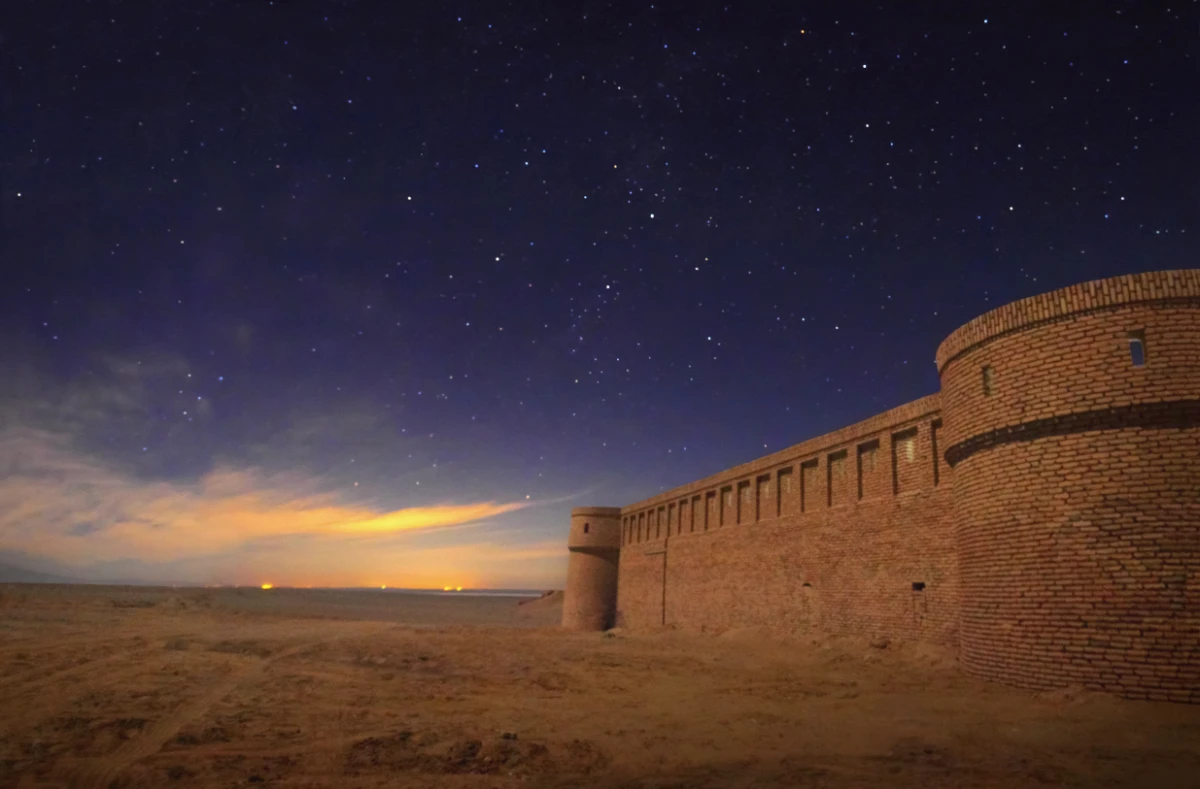 An ancient Iranian caravanserai (caravan serai) at the background of night sky full of stars and sunset in Maranjab desert near Kashan and Aran va Bidgol, Iran. (Shutterstock)