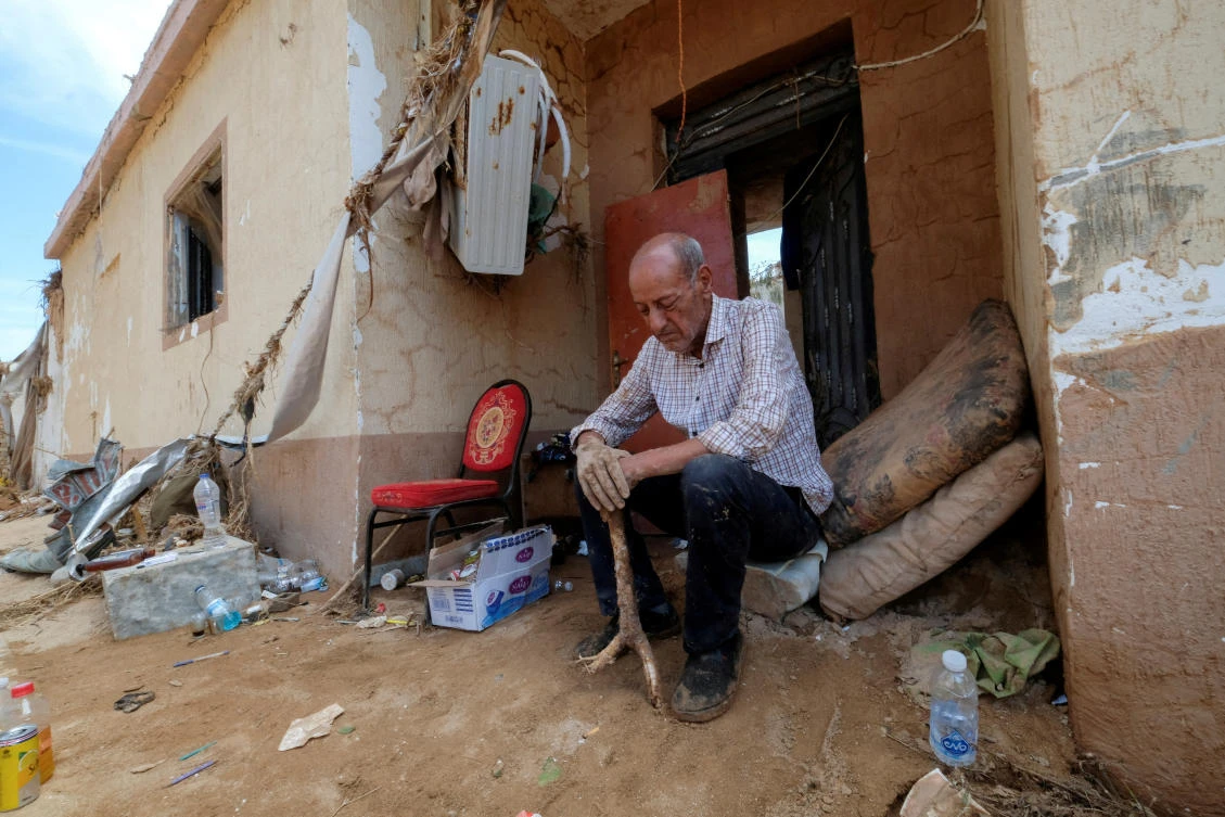 Hassan Kassar, 69, who said he lost his daughters, two of his sons and his granddaughter when the deadly storm hit the city, sits outside his damaged house, in Derna, Libya September 17, 2023. (Reuters)