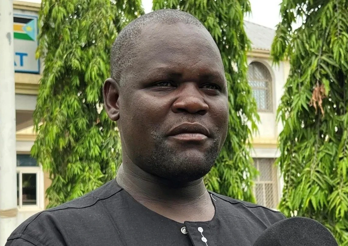In the video, Emmanuel Khamis Richard, the acting mayor of the African nation's capital, is seen wielding a pistol and walking up to where a policeman and a woman vendor are scuffling. He slapped the woman and walked away as the police operation continued. (X/@RadioOneSS)